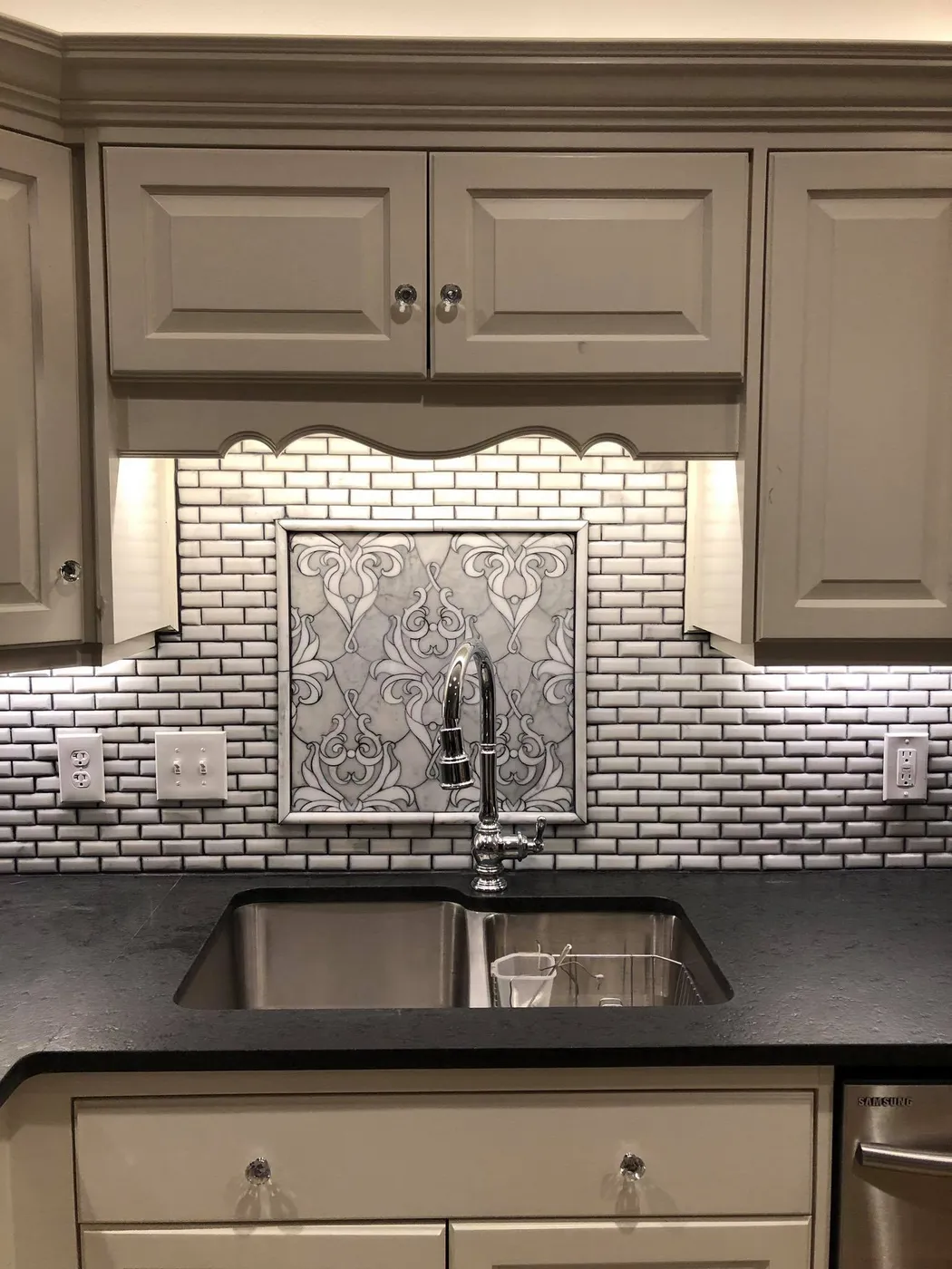 Tile backsplash and fixture detail work in a kitchen renovation